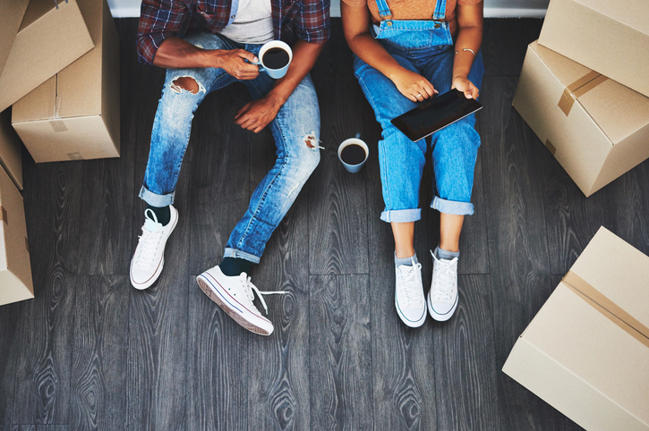 High angle shot of an unrecognizable couple using a tablet in their new home