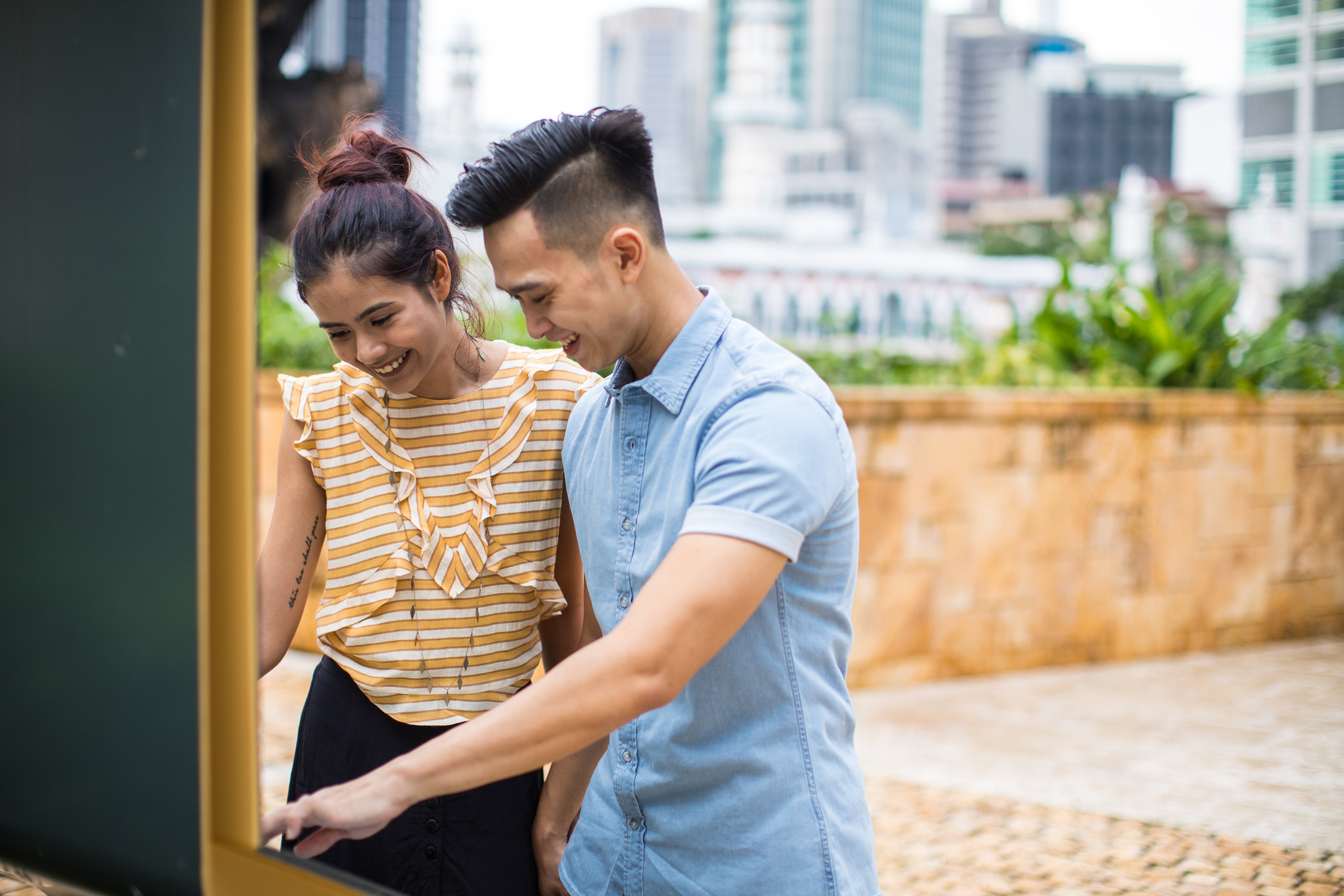 Young beautiful tourist couple enjoy sightseeing in Kuala Lumpur, Malaysia