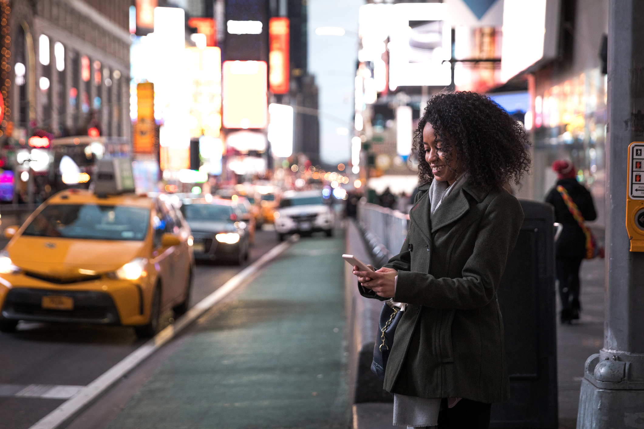 Waiting for the taxi in Times Square New York, USA. Using social media.