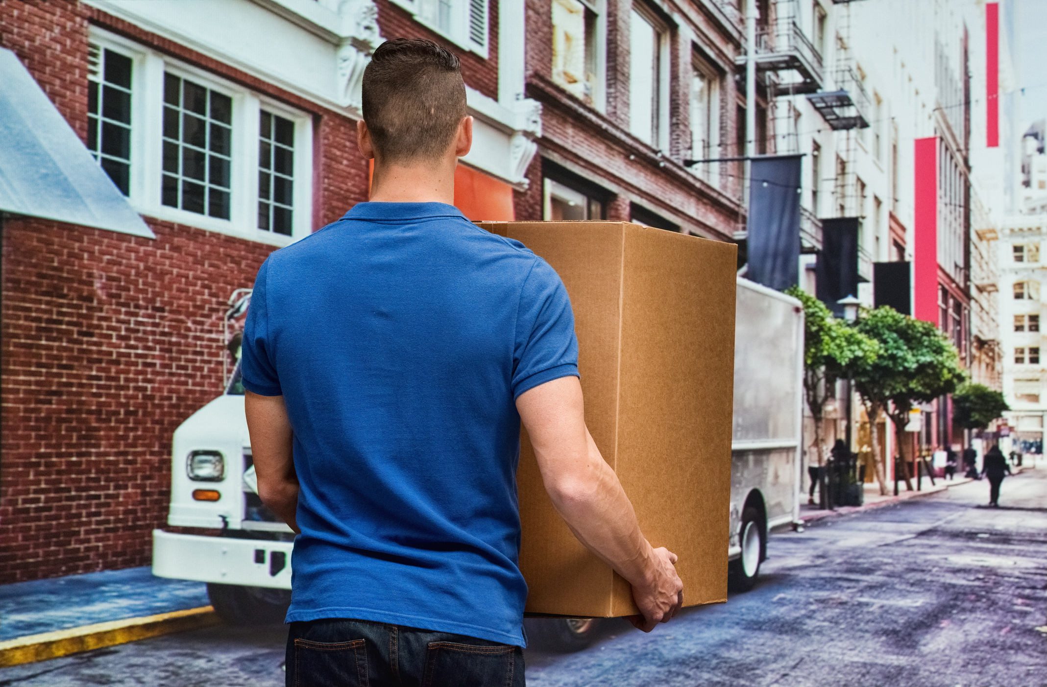 Rear view of worker holding box outdoor