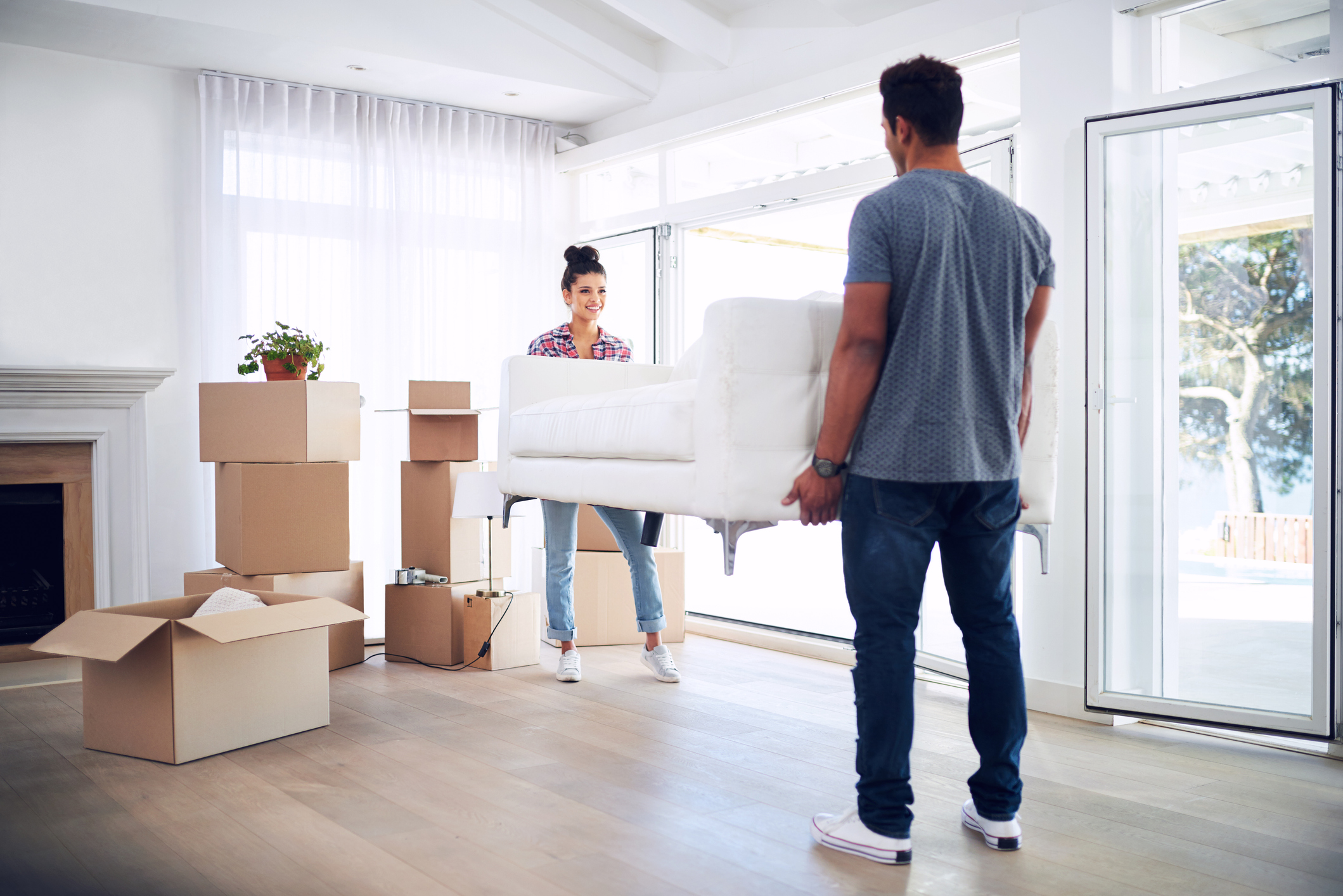 Shot of a young couple moving into their new place