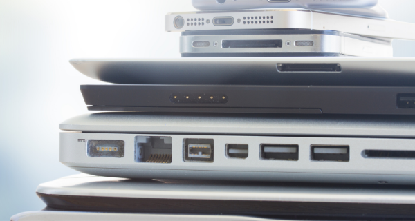 Image of computers and cellphones in a stack.