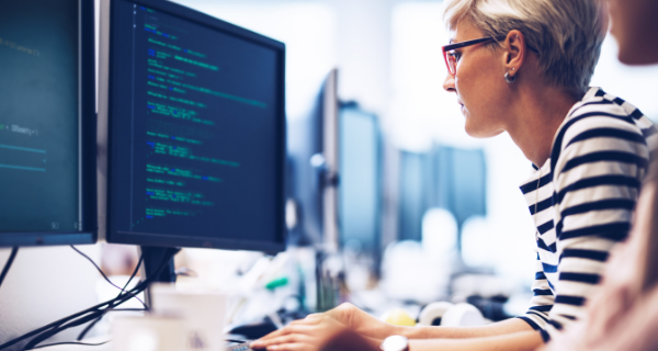 Photo of woman coding on computer.