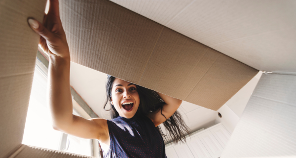 Woman looking into cardboard box.