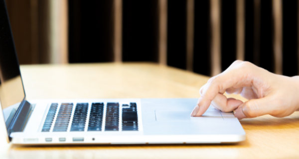 Image of person using a computer from above, and not clicking.