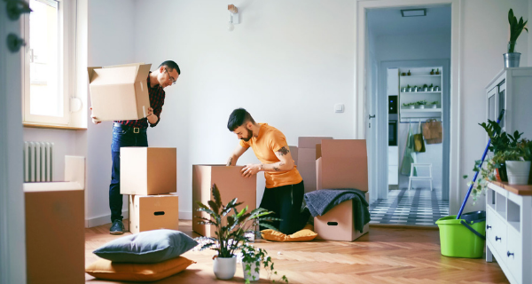Two people packing boxes to move.