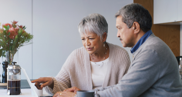 senior couple looks at a website